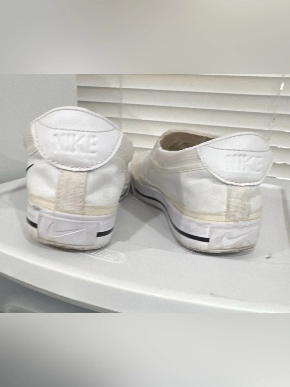 Nike Women’s White Slip-On Sneakers with Black Swoosh Accent